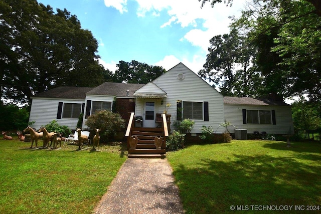 view of front of property with a front lawn and cooling unit