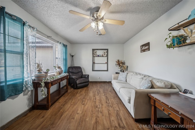 living room featuring a textured ceiling, hardwood / wood-style flooring, and ceiling fan