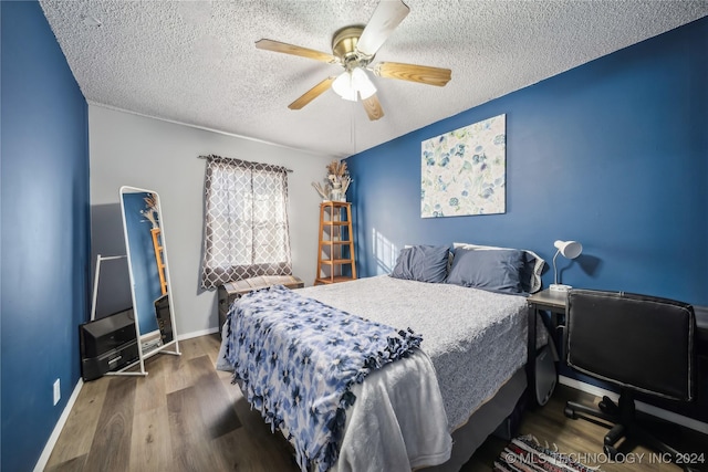 bedroom featuring ceiling fan, a textured ceiling, and hardwood / wood-style flooring