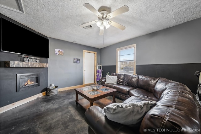 living room featuring a textured ceiling and ceiling fan