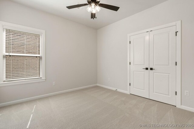 2601 W Twin Oaks St, Broken Arrow, OK 74012 - unfurnished bedroom featuring baseboards, light colored carpet, a closet, and a ceiling fan