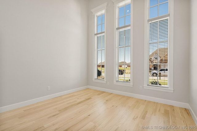 2601 W Twin Oaks St, Broken Arrow, OK 74012 - spare room featuring baseboards and wood finished floors