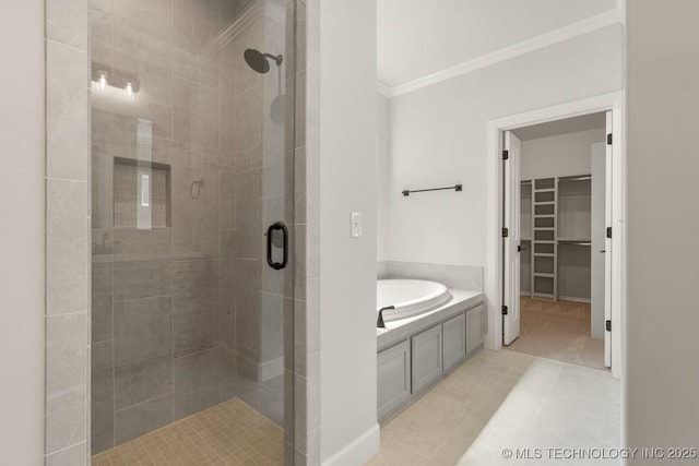 2601 W Twin Oaks St, Broken Arrow, OK 74012 - bathroom with ornamental molding, a stall shower, a bath, a spacious closet, and tile patterned floors