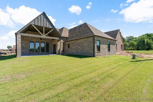 2601 W Twin Oaks St, Broken Arrow, OK 74012 - back of property featuring brick siding, a lawn, and board and batten siding