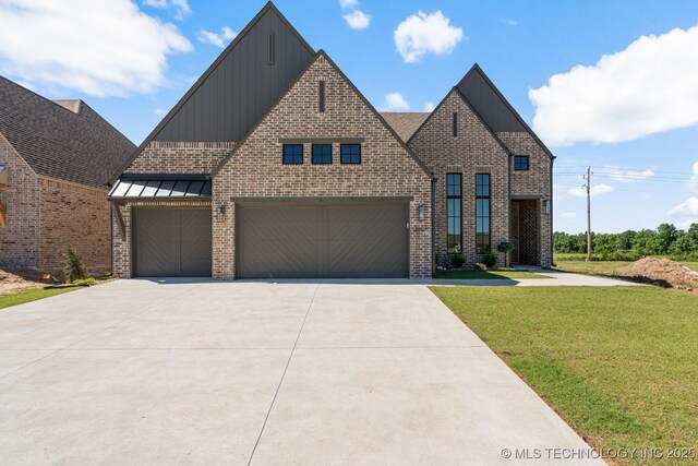 2601 W Twin Oaks St, Broken Arrow, OK 74012 - view of front of property with board and batten siding, driveway, a front yard, and brick siding