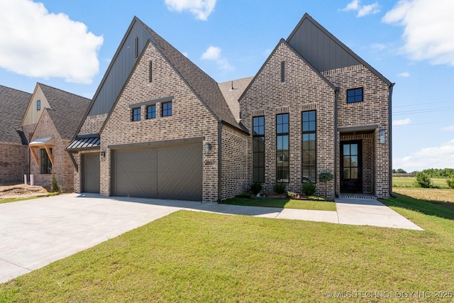 2601 W Twin Oaks St, Broken Arrow, OK 74012 - view of front of home with board and batten siding, concrete driveway, a front lawn, and brick siding