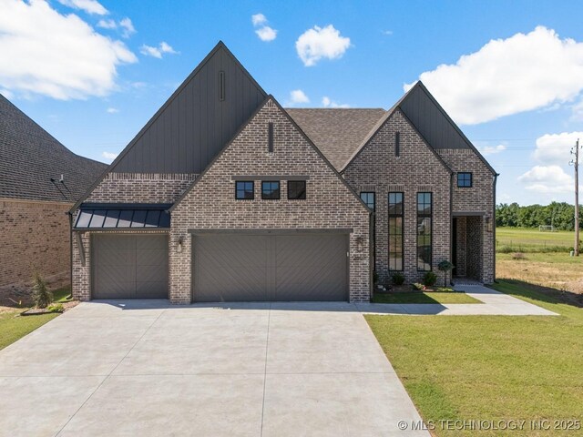 2601 W Twin Oaks St, Broken Arrow, OK 74012 - view of front of house featuring board and batten siding, concrete driveway, a front yard, and brick siding
