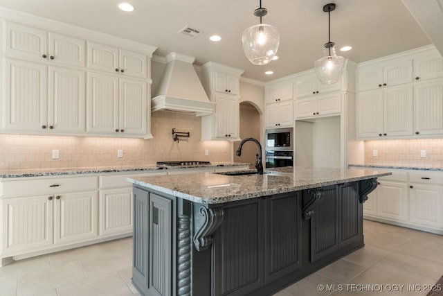 17413 S 52nd E Ave, Bixby, OK 74008 - kitchen featuring premium range hood, a sink, appliances with stainless steel finishes, tasteful backsplash, and light tile patterned floors