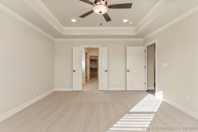 17413 S 52nd E Ave, Bixby, OK 74008 - unfurnished bedroom with a raised ceiling, light colored carpet, crown molding, a walk in closet, and baseboards