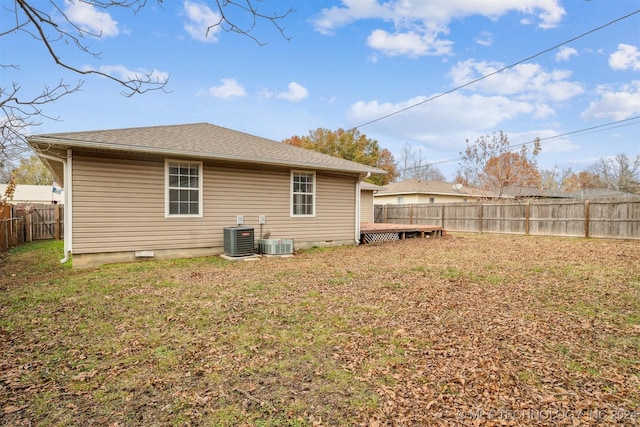 back of property featuring central AC unit, a yard, and a wooden deck