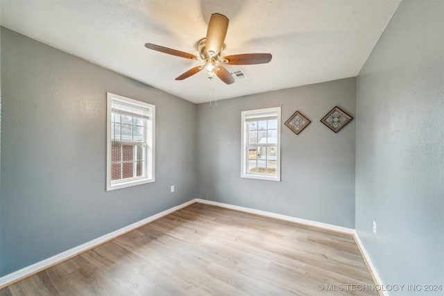 empty room with light hardwood / wood-style floors and ceiling fan