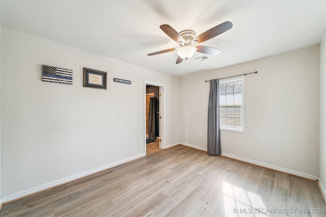 unfurnished room featuring ceiling fan and light wood-type flooring