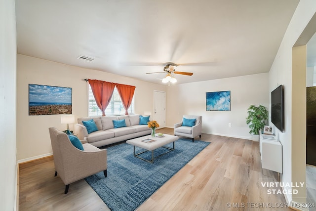 living room with ceiling fan and light hardwood / wood-style flooring