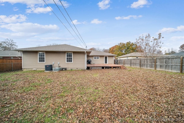 rear view of property with central air condition unit and a wooden deck