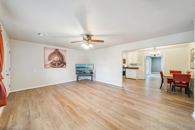 living room featuring light hardwood / wood-style floors and ceiling fan with notable chandelier