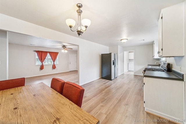 dining area featuring ceiling fan with notable chandelier and light hardwood / wood-style flooring