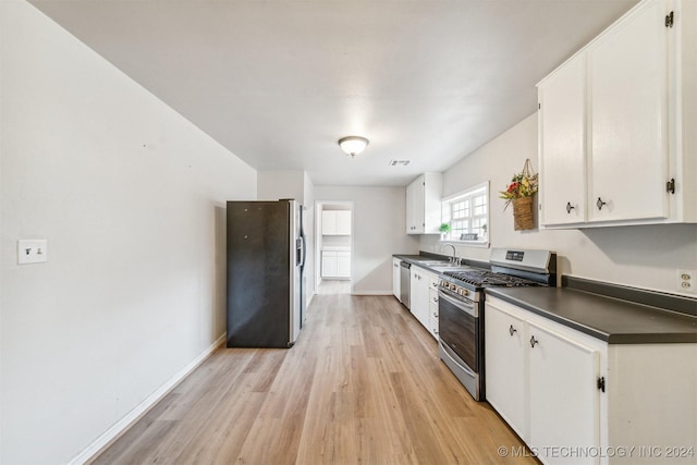 kitchen featuring light hardwood / wood-style flooring, white cabinets, stainless steel appliances, and sink