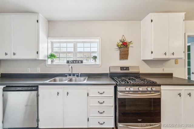 kitchen featuring white cabinets, stainless steel appliances, and sink