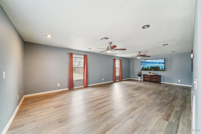 unfurnished living room with light wood-type flooring and ceiling fan