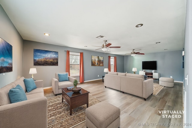 living room featuring ceiling fan and light wood-type flooring