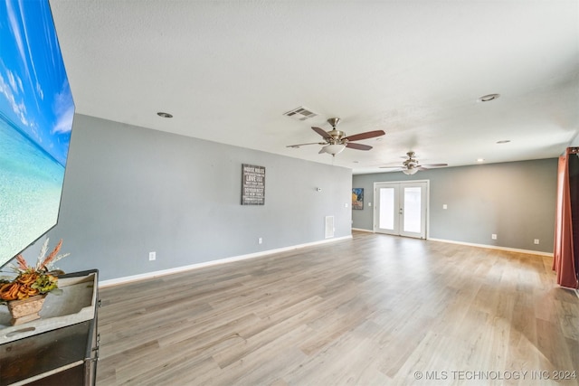 unfurnished room with ceiling fan, light hardwood / wood-style flooring, and french doors