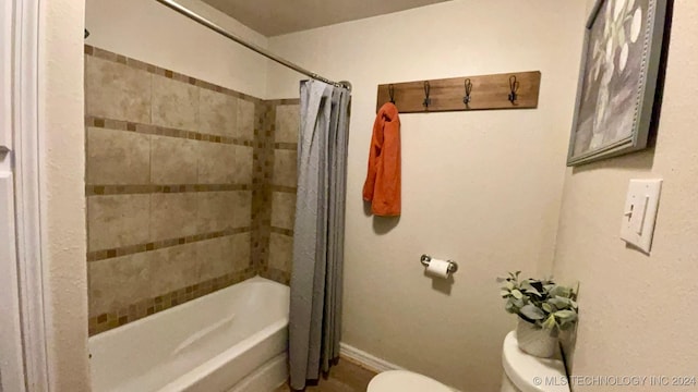 bathroom featuring toilet and shower / bathtub combination with curtain