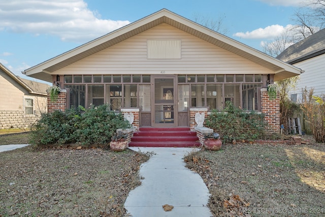 bungalow-style house with a sunroom