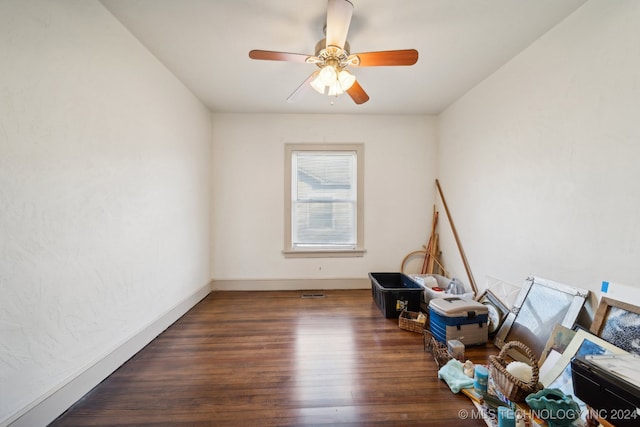 unfurnished room with ceiling fan and dark hardwood / wood-style flooring