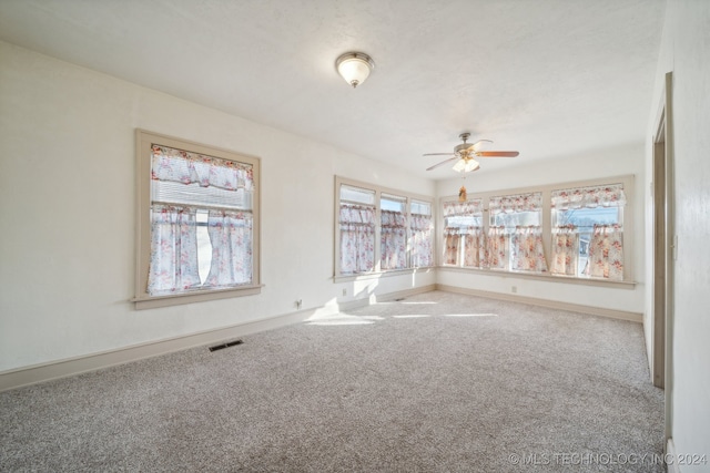 carpeted empty room with ceiling fan