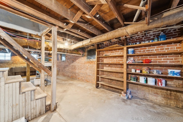 basement with brick wall