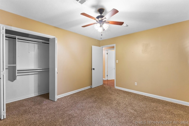 unfurnished bedroom with carpet flooring, ceiling fan, and a closet