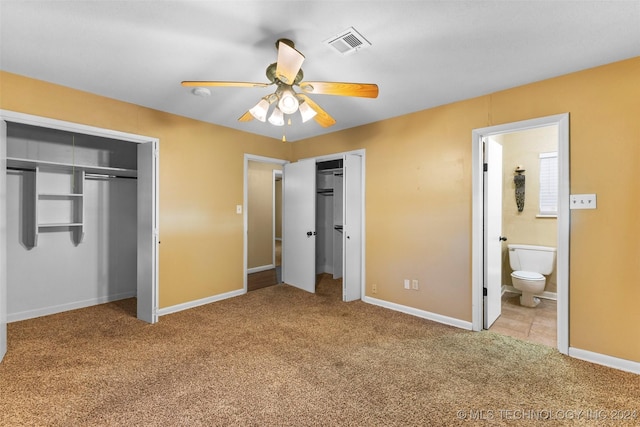 unfurnished bedroom featuring connected bathroom, light colored carpet, and ceiling fan