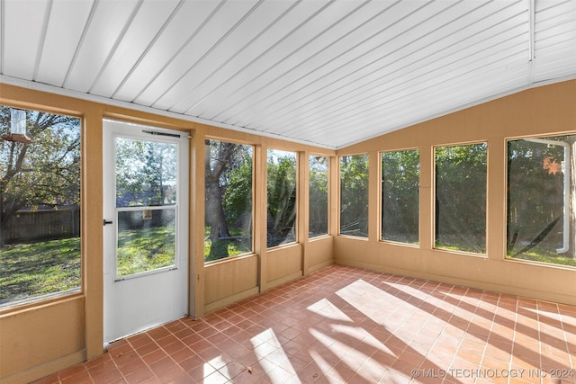 unfurnished sunroom featuring vaulted ceiling