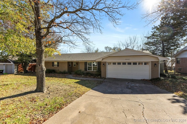 ranch-style house with a front lawn and a garage