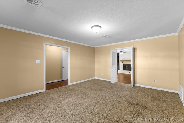 carpeted spare room with a textured ceiling and ornamental molding