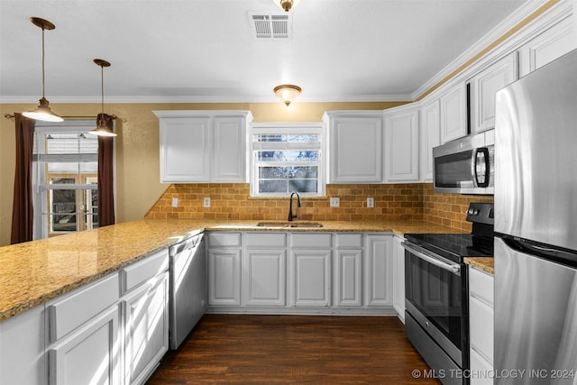 kitchen featuring white cabinetry, sink, dark wood-type flooring, stainless steel appliances, and pendant lighting