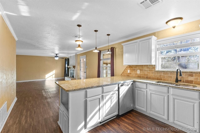 kitchen with kitchen peninsula, dark hardwood / wood-style flooring, white cabinetry, and sink