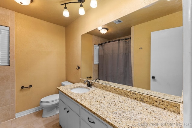 bathroom with tile patterned flooring, vanity, a shower with shower curtain, and toilet