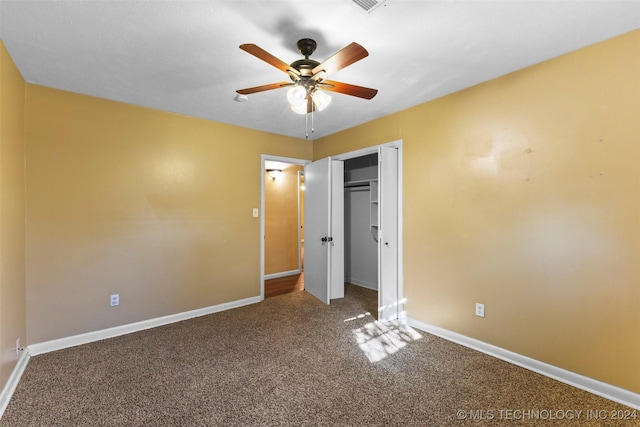 unfurnished bedroom with carpet, a closet, and ceiling fan