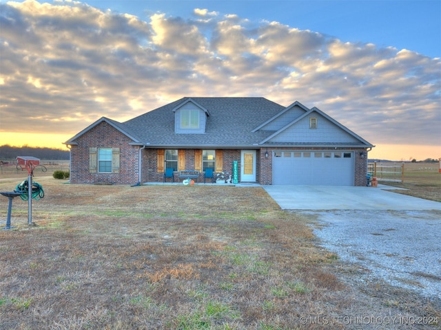 view of front facade featuring a garage and a lawn