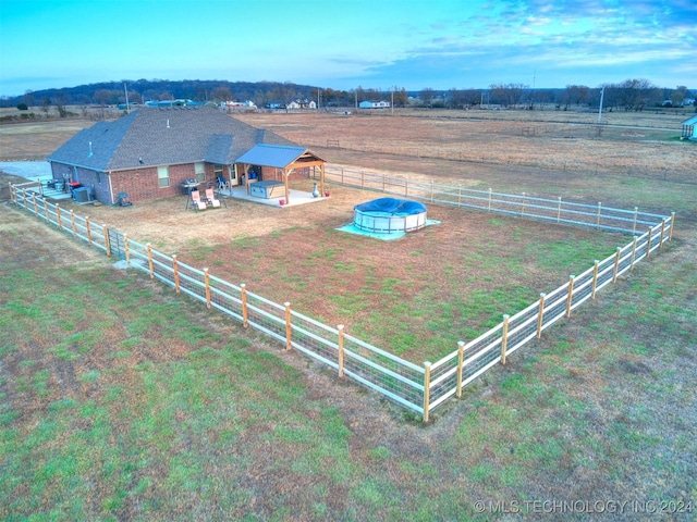 birds eye view of property featuring a rural view