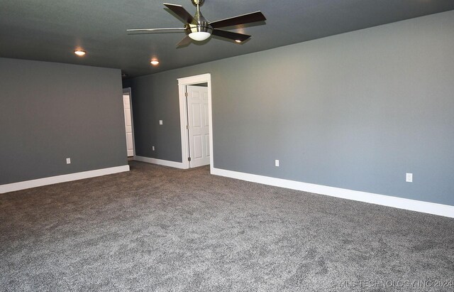 carpeted spare room featuring ceiling fan