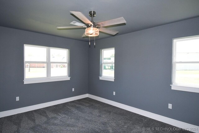 unfurnished room featuring carpet, plenty of natural light, and ceiling fan