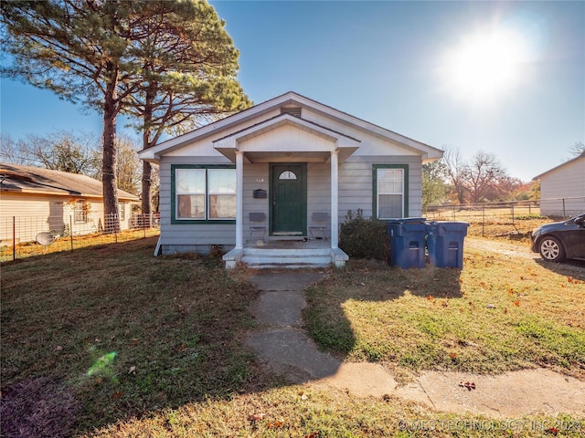 bungalow-style house featuring a front yard