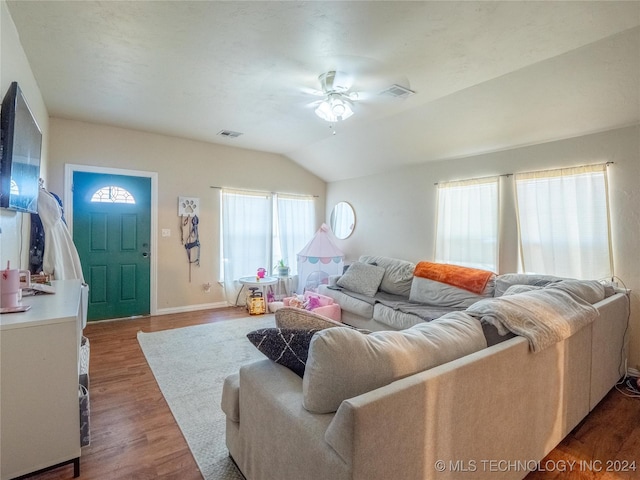 living room with ceiling fan, dark hardwood / wood-style floors, and lofted ceiling