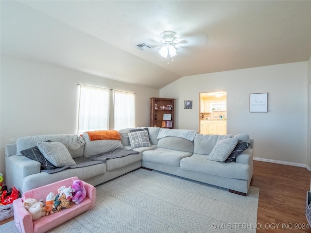 living room with hardwood / wood-style floors, ceiling fan, and lofted ceiling