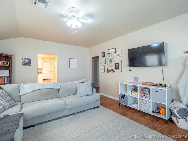 living room featuring hardwood / wood-style flooring, ceiling fan, and lofted ceiling