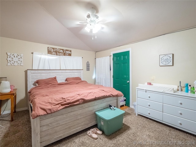 carpeted bedroom with ceiling fan and vaulted ceiling