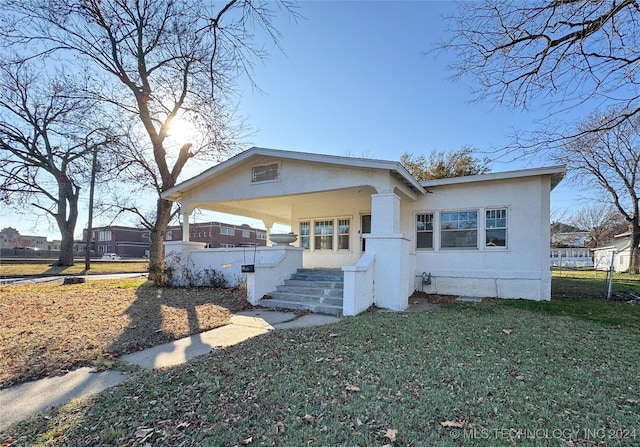 view of front of property with a porch and a front lawn