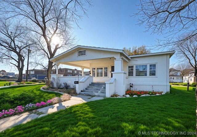 view of front of home featuring a porch and a front lawn